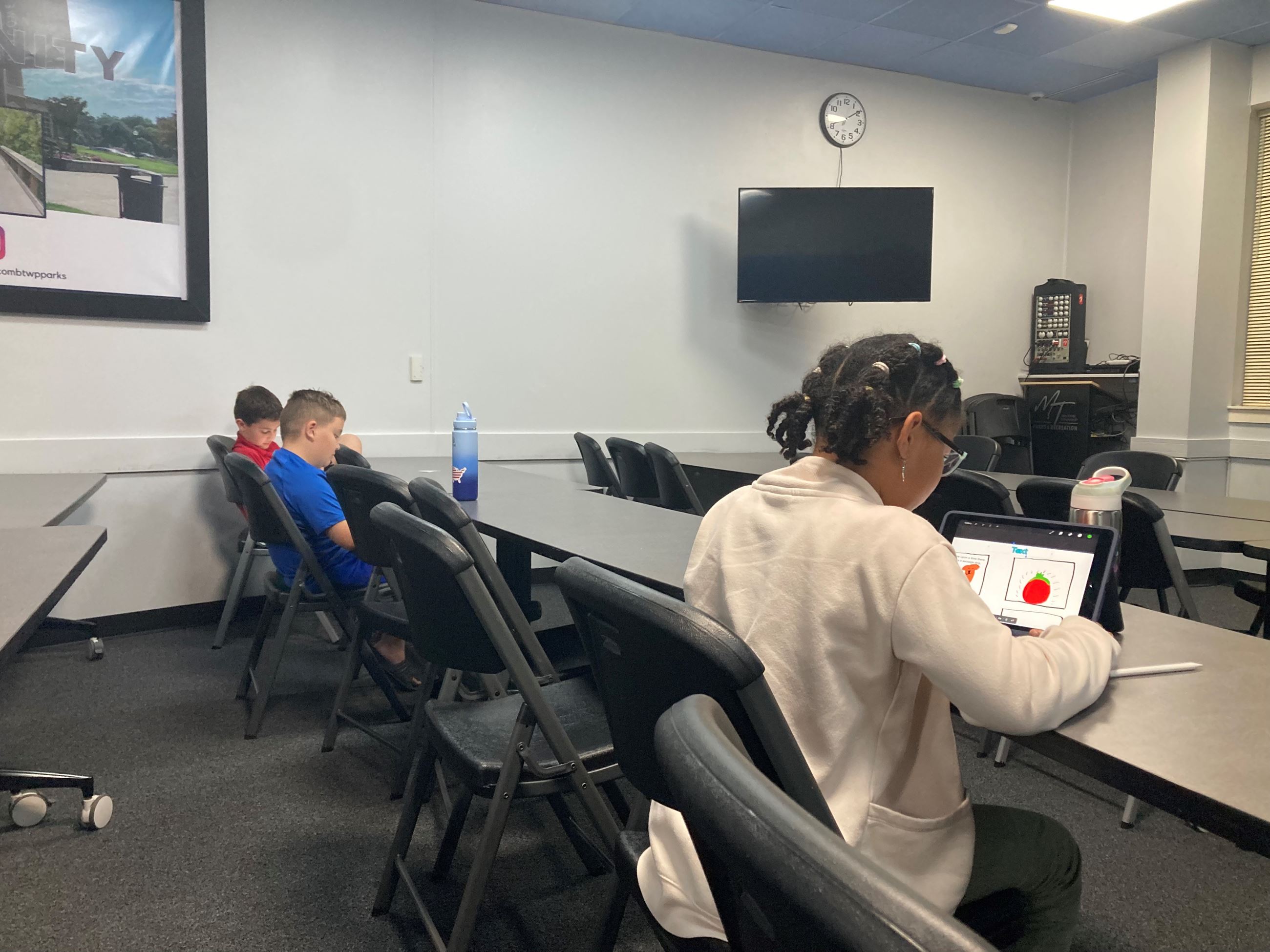 Participants creating stories in the Digital Comic Making Series—creative fall programming for all ages.